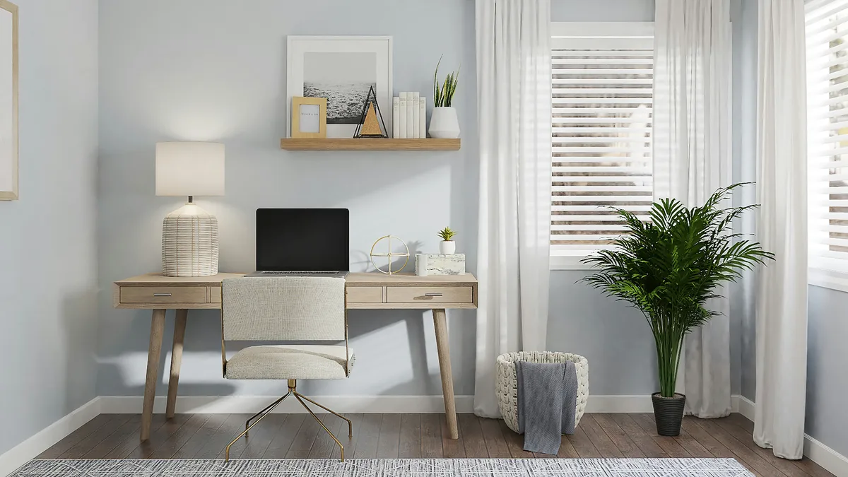 Compact home office nook with wooden desk laptop floating shelf and plant
