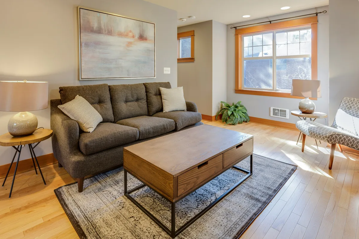 Cozy living room with brown sofa and wooden storage coffee table with drawers