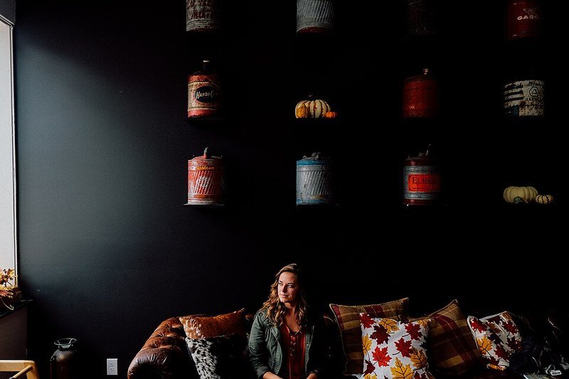 Cozy fall throw pillows and blankets layered on a small apartment couch