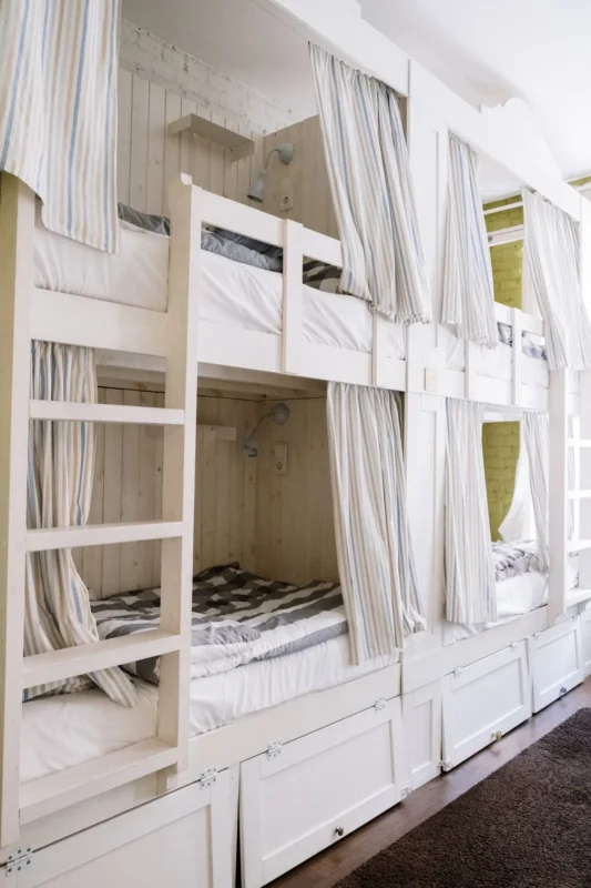 White bunk beds with storage drawers built under the lower bunk