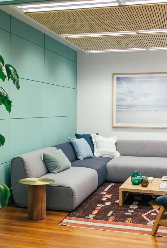 Light living room with couch, pillows and small side table