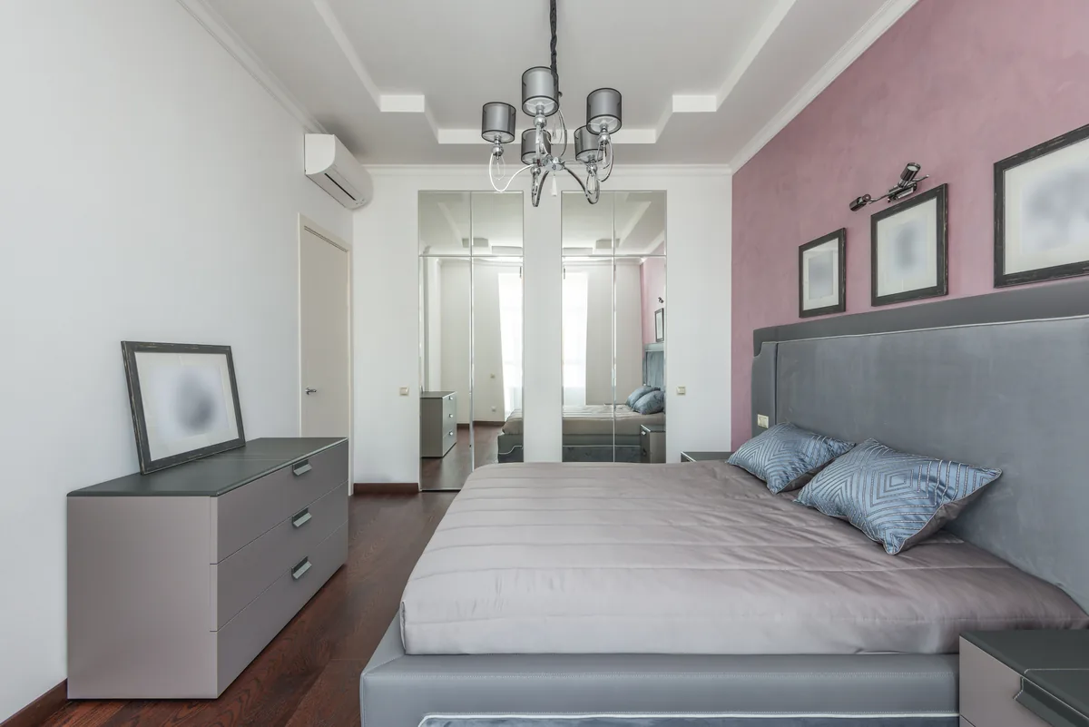 Small luxurious bedroom with a king-sized upholstered bed
