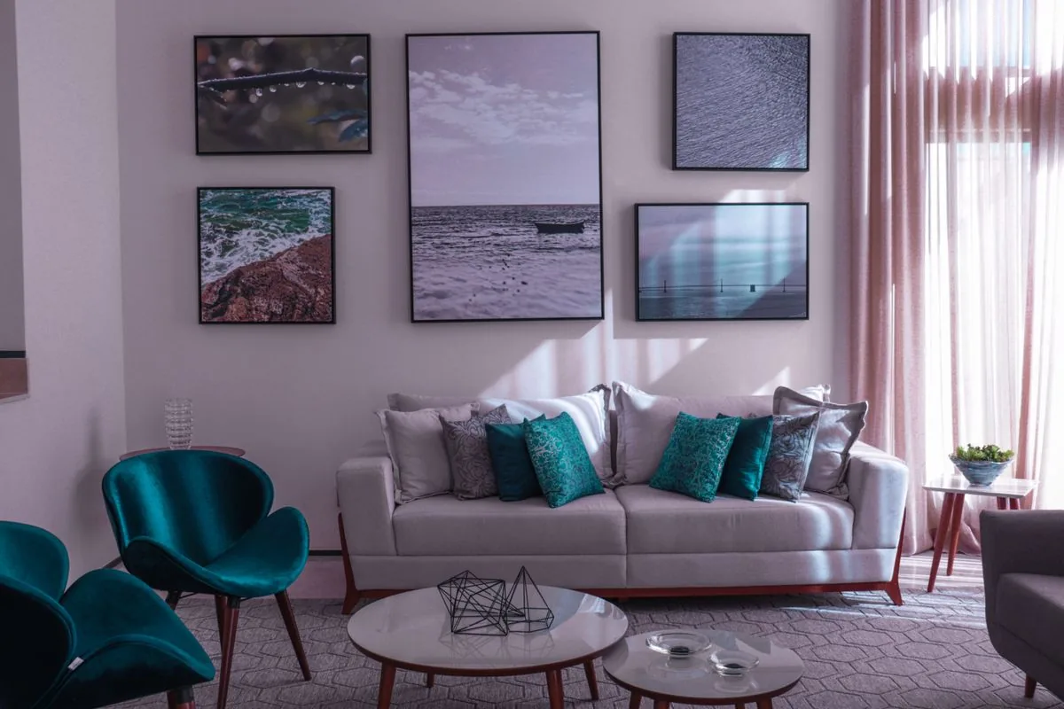 Living room with teal accent decor and framed artwork