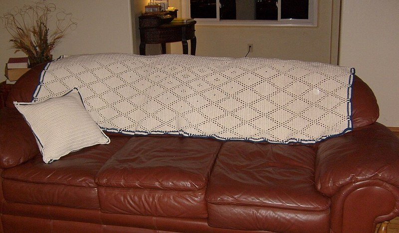 Crochet throw blanket on sofa, dollar store cozy throw styling idea