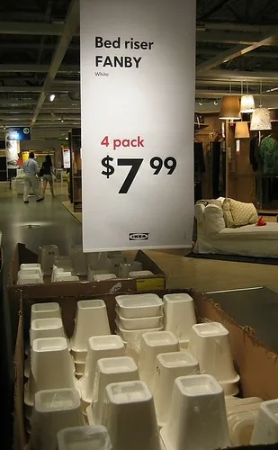 Bed risers on a store display shelf