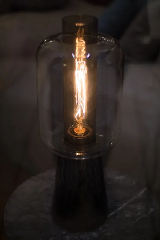 Glass Edison-bulb table lamp on a desk