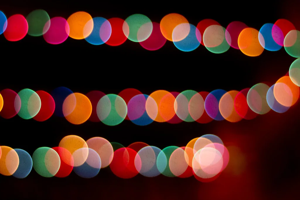 Close-up of colorful string lights glowing