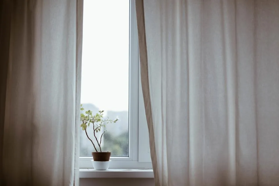 Window with curtains hung in a rental room