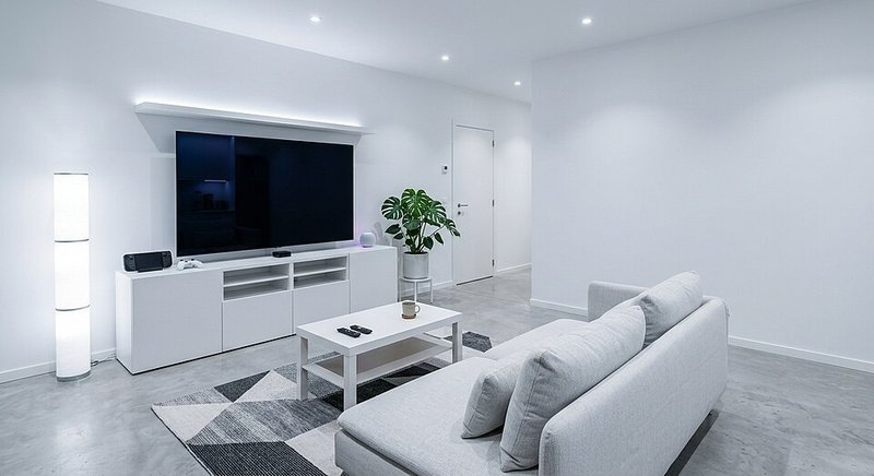 Small apartment living room with rearranged sofa and chairs showing a free furniture layout refresh