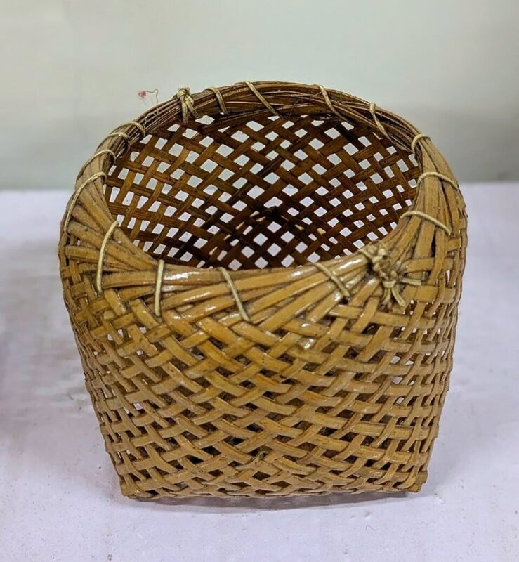 Woven bamboo storage basket for hiding clutter in a small apartment on a budget