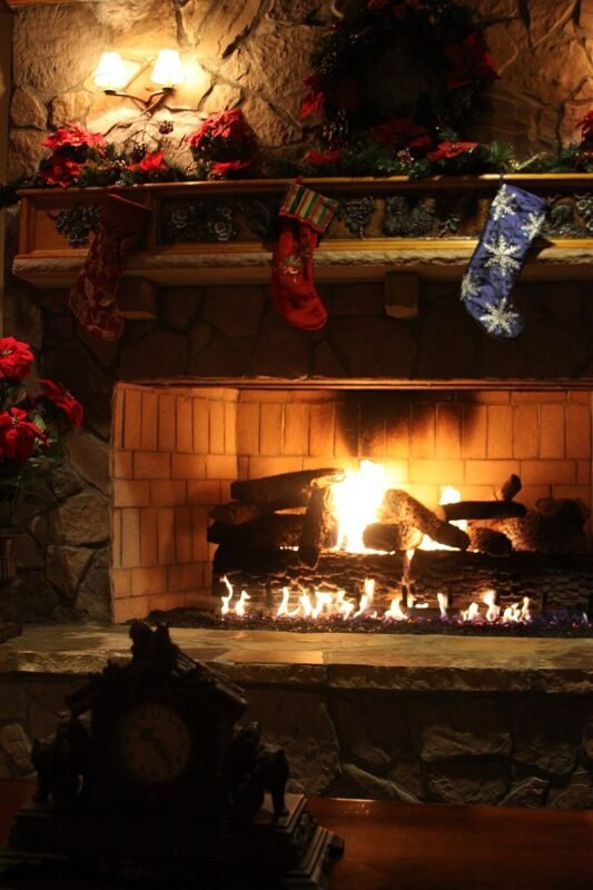 Cozy Christmas fireplace with knit stockings hung above the mantel