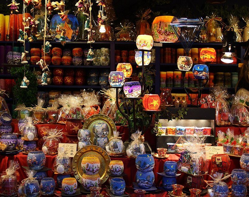 Colorful glowing Christmas candle lanterns at a winter market stall