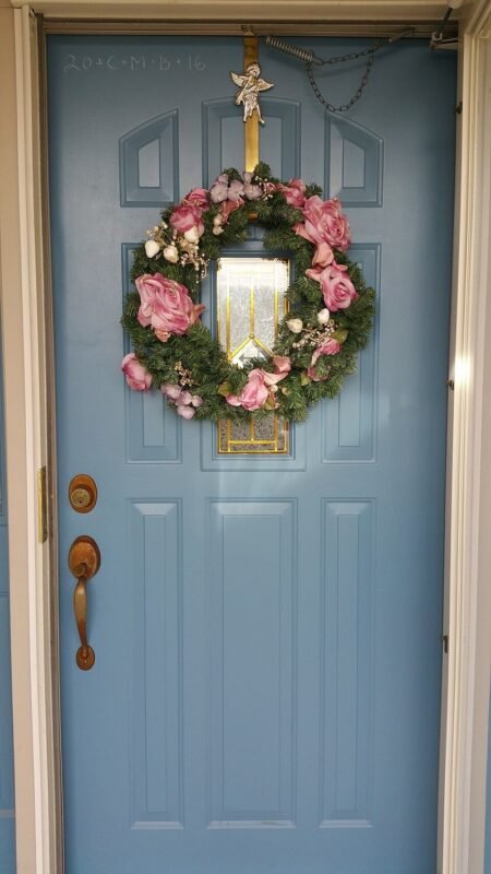 Fresh green Christmas wreath with red bow for holiday wall decor