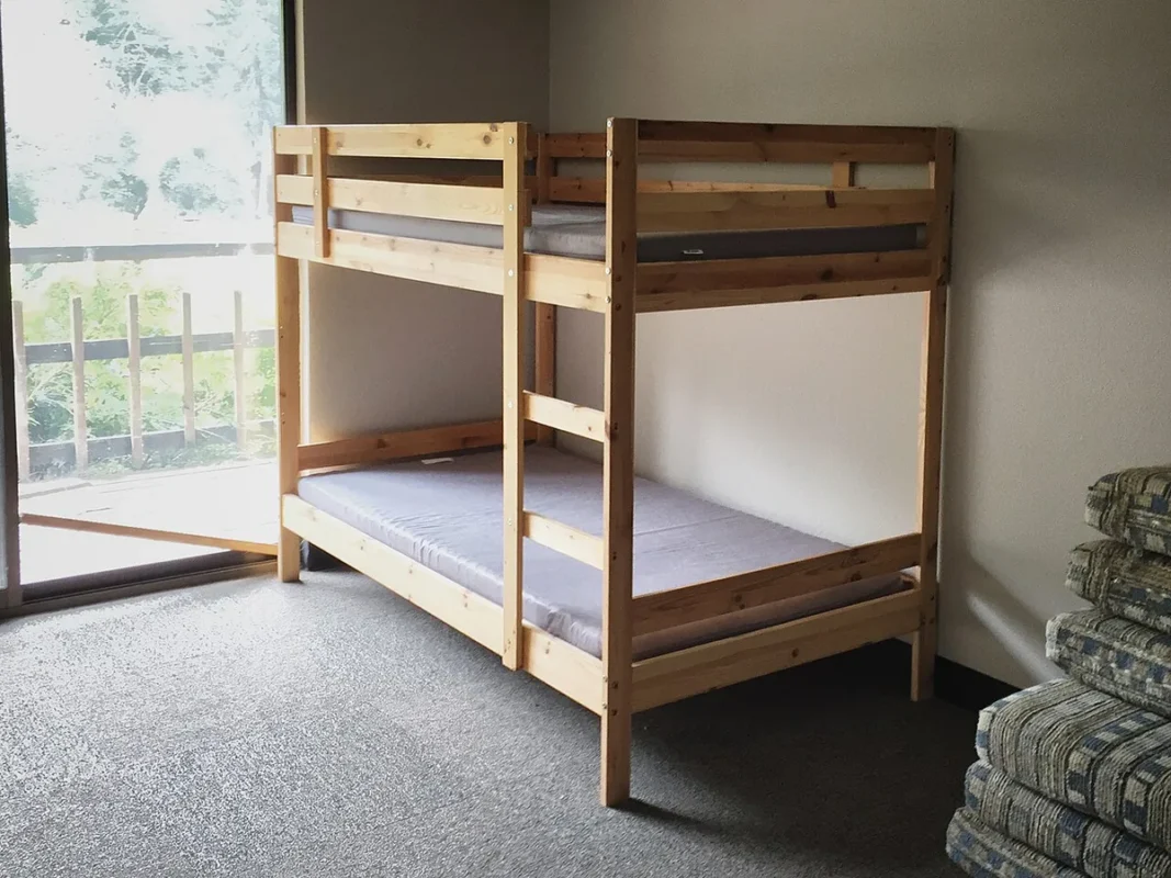 Wooden bunk bed freeing up floor space in a small bedroom
