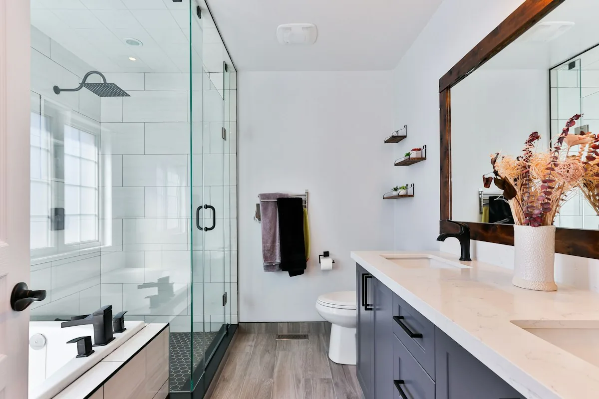 Modern bathroom with floating wall shelves holding plants beside the toilet