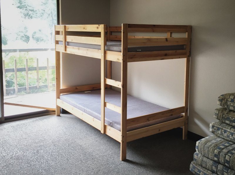 Wooden bunk bed lofting the sleeping area to free up floor space below