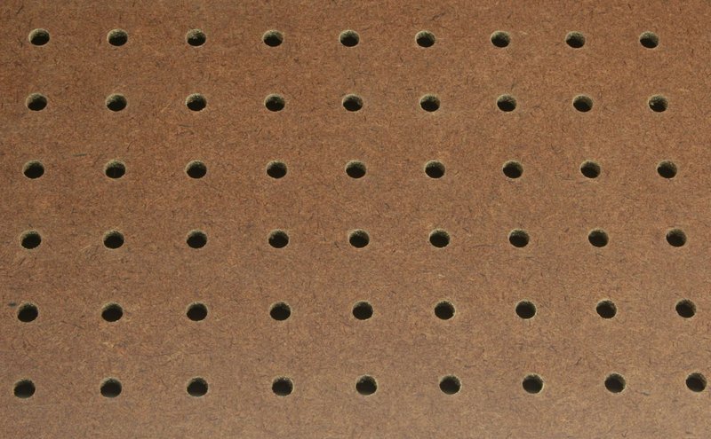Pegboard wall organizer holding tools and supplies for small space storage