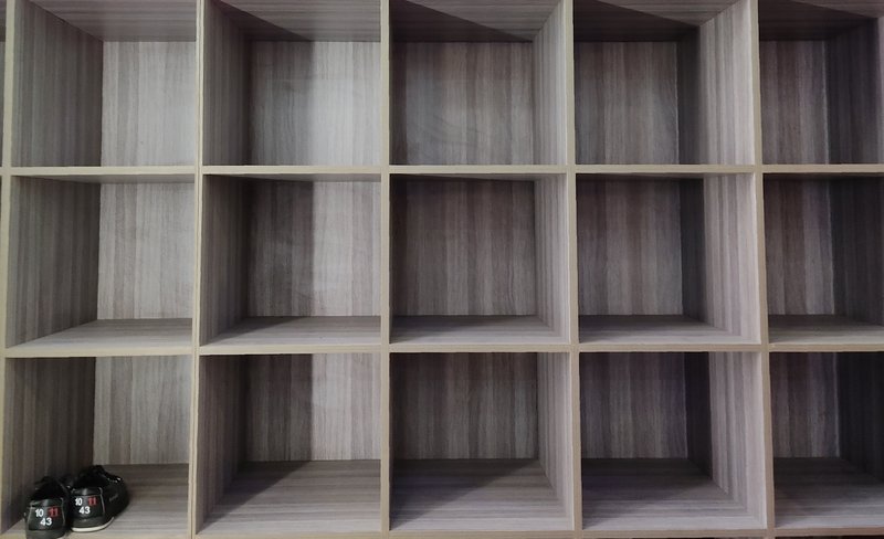 Vertical shoe rack organizing footwear in a narrow closet space