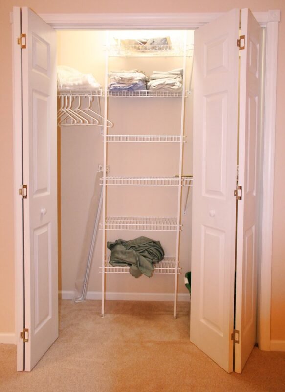 Full-height wall closet providing floor-to-ceiling wardrobe storage