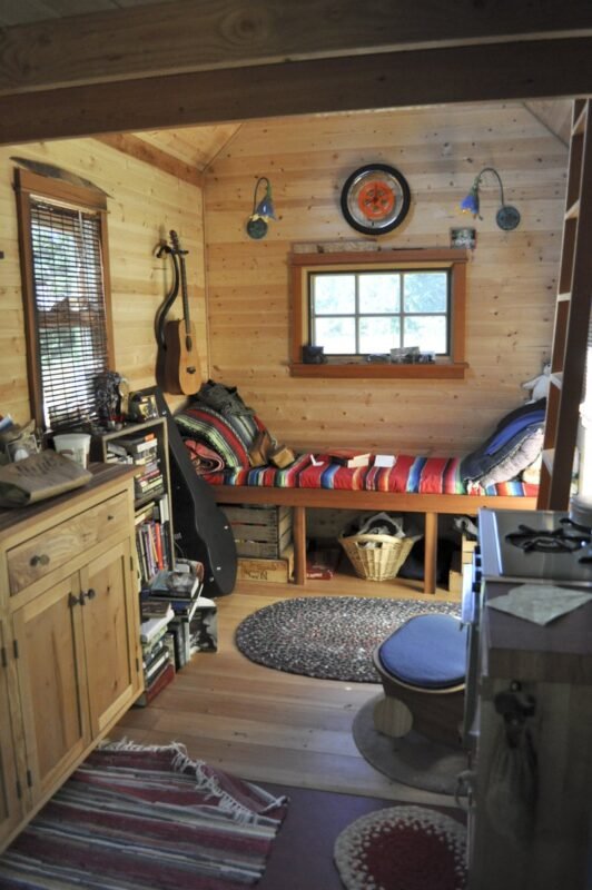 Tiny house interior showing multipurpose furniture in a compact living space