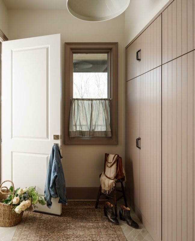 Tidy mudroom entryway with bench storage and wall hooks for a calm tiny living arrival