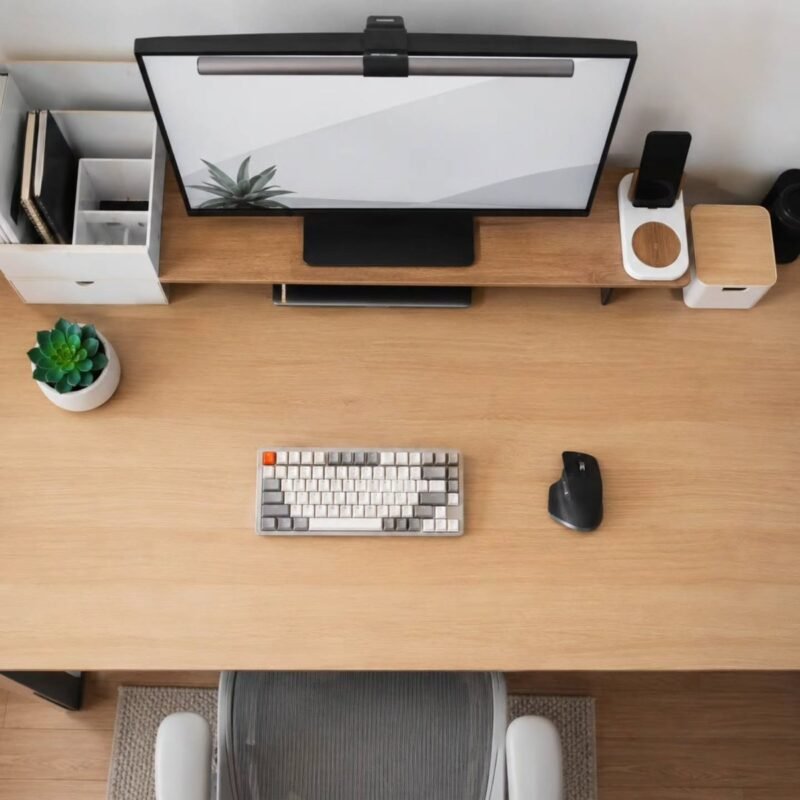 Minimalist clear desk setup with laptop and plant for focused tiny living work