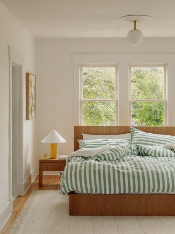 Serene decluttered bedroom sanctuary with simple bedding to declutter your mind