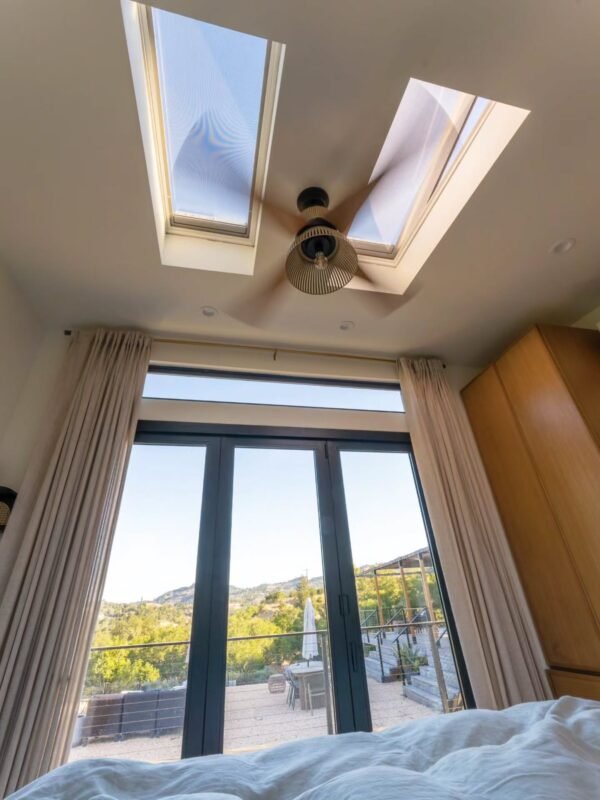 Peaceful decluttered bedroom with skylights for restful sleep