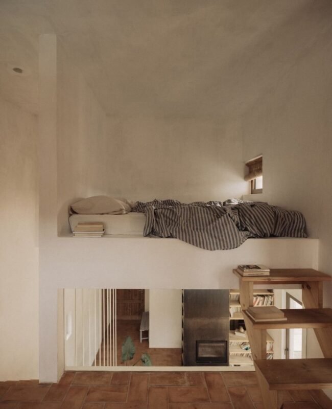 Minimalist white loft bedroom with simple bedding, clutter-free tiny living bedroom for mental calm