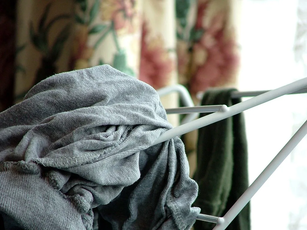 Clothes drying on a white indoor rack