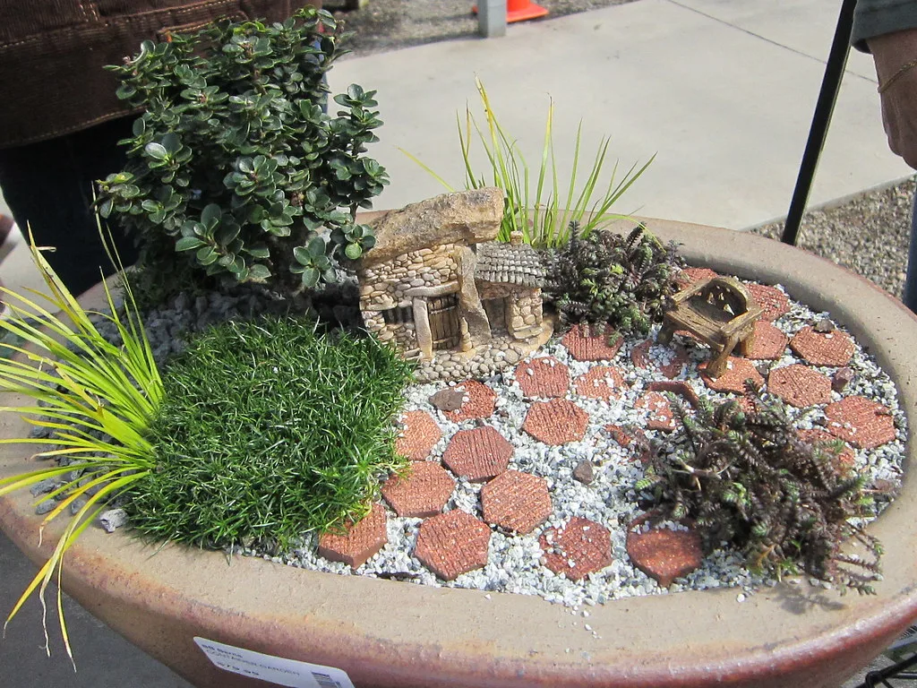 Miniature fairy garden with a tiny stone house
