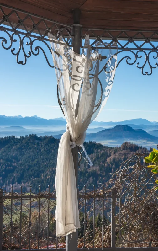 Sheer outdoor curtain tied to a pavilion post