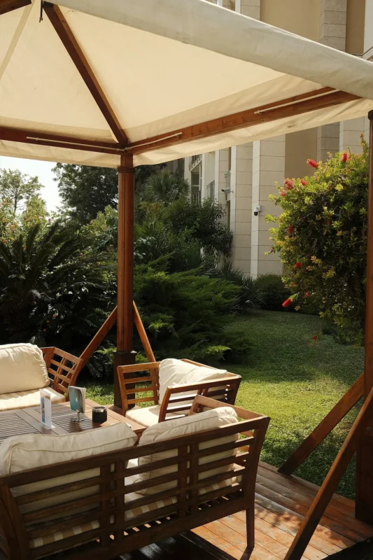 Gazebo seating area with weatherproof cushioned chairs
