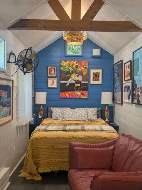 Colorful small bedroom with blue accent wall and mustard yellow bedding