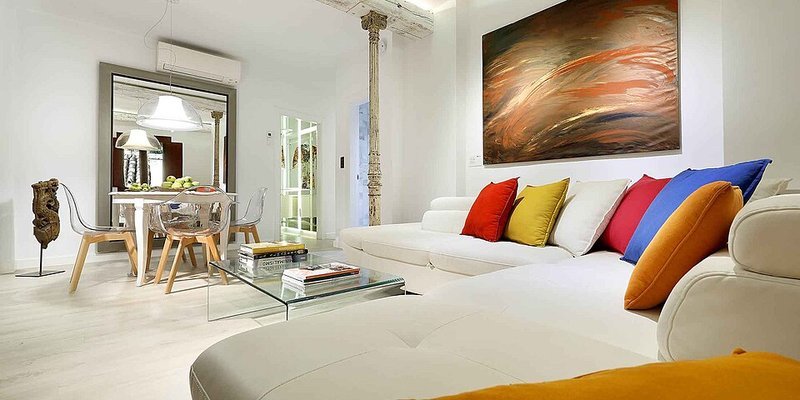 Large wall mirror reflecting a small living room to double the sense of space