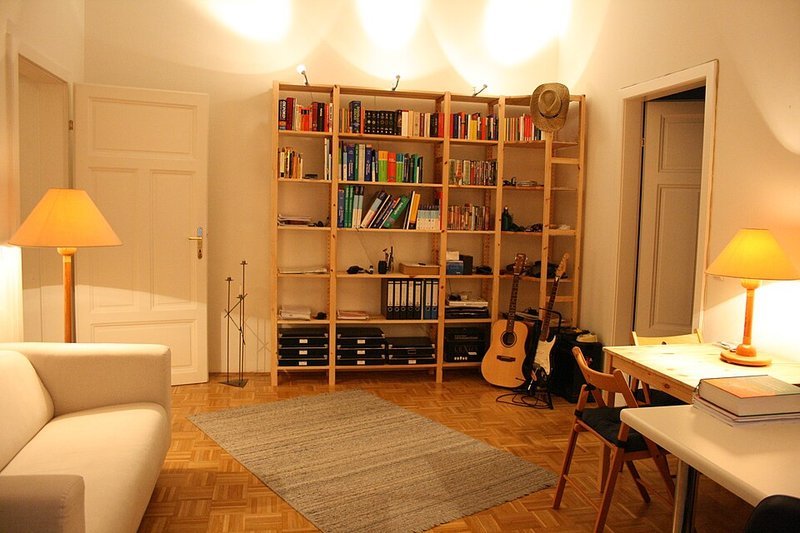 Living room with warm layered lighting from a floor lamp table lamp and spots
