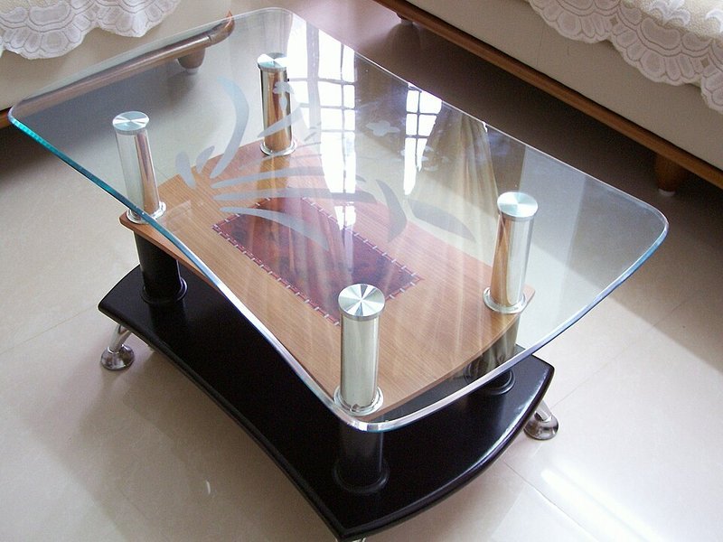Glass-top coffee table with slim legs keeping sightlines open and airy